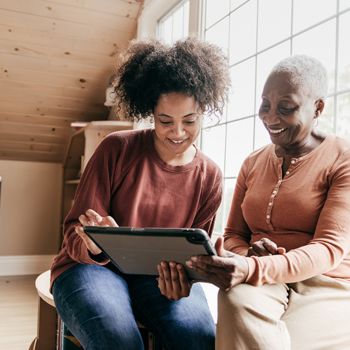 A woman and her older mother video chat with a Home Loan Consultant from Patelco.