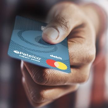 A man gets ready to pay for a purchase with the Patelco debit card.