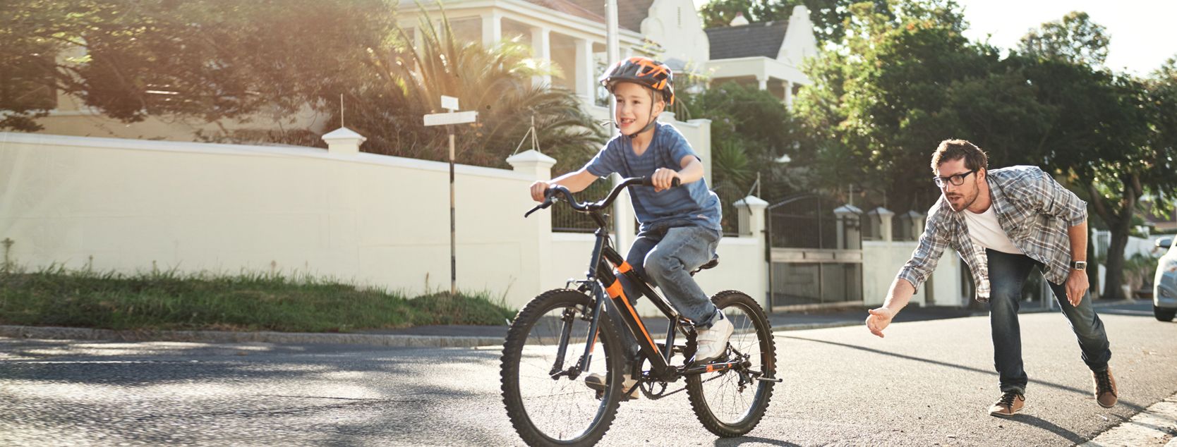 Child on bike with father