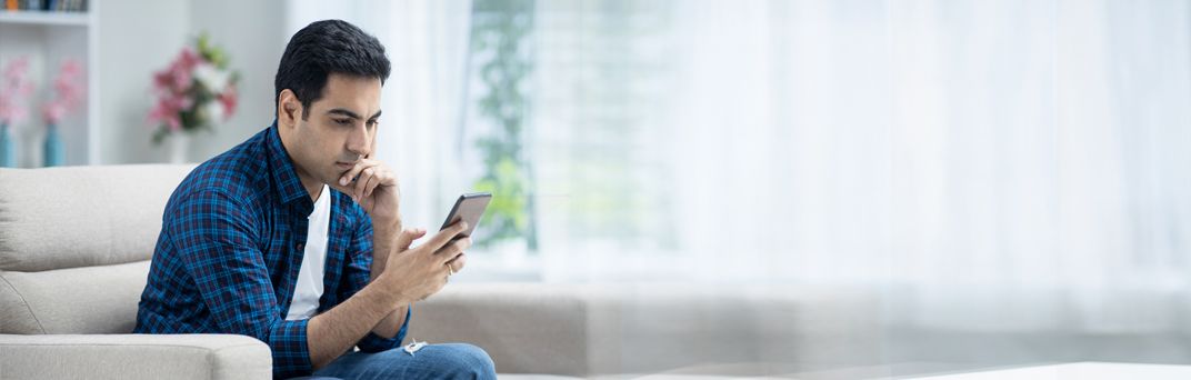 A man uses the Patelco Mobile App to access his bank account details.