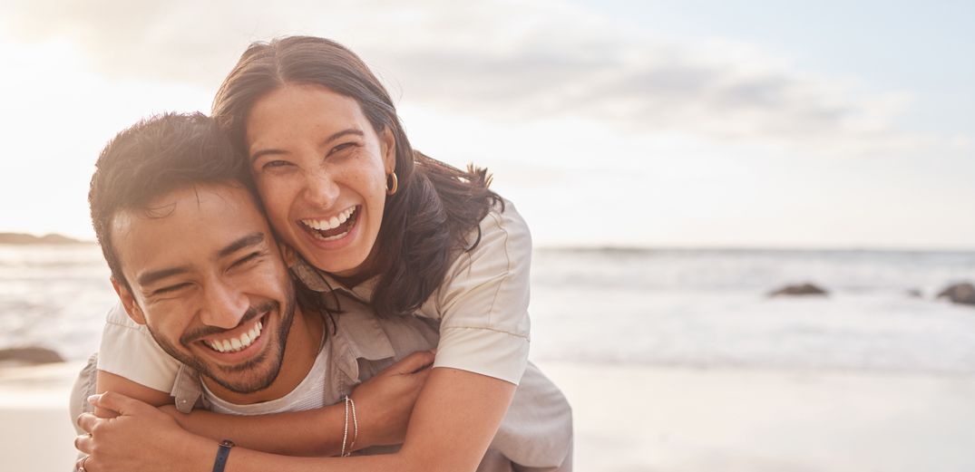 A young couple has fun at the beach.