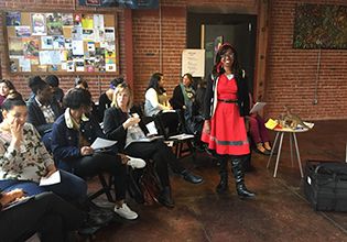 Patelco Team Member teaches a financial education course to people in the community photo