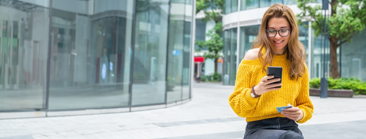 Woman using a debit card to access her Patelco interest checking account