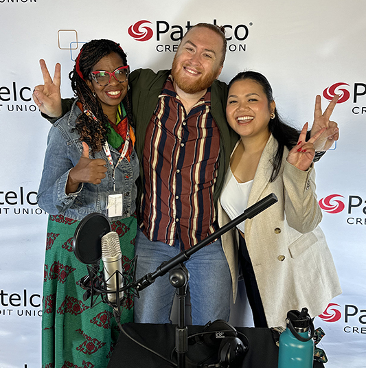 Patelco employees Andrew Farrell, Veronica Dangerfield, and Uslea Evangelista at the podcast desk.